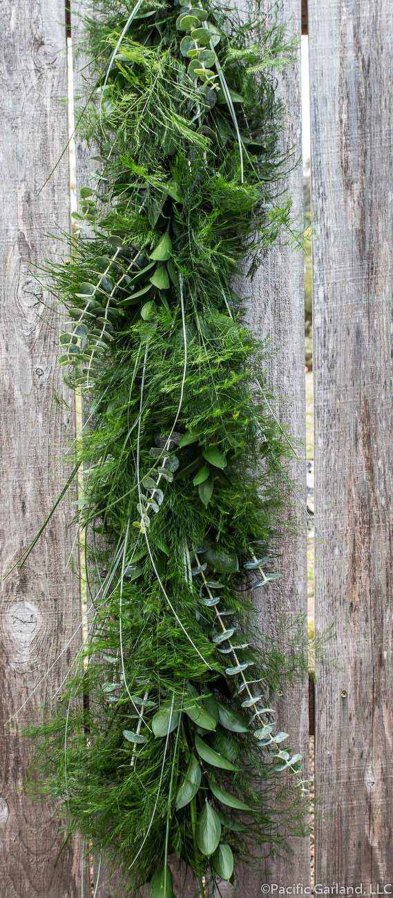 Stunning Ruscus Rave! 'Signature Series' Garland hanging on Wood Fence