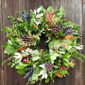 fresh everlasting wreath with lotus pods on fence