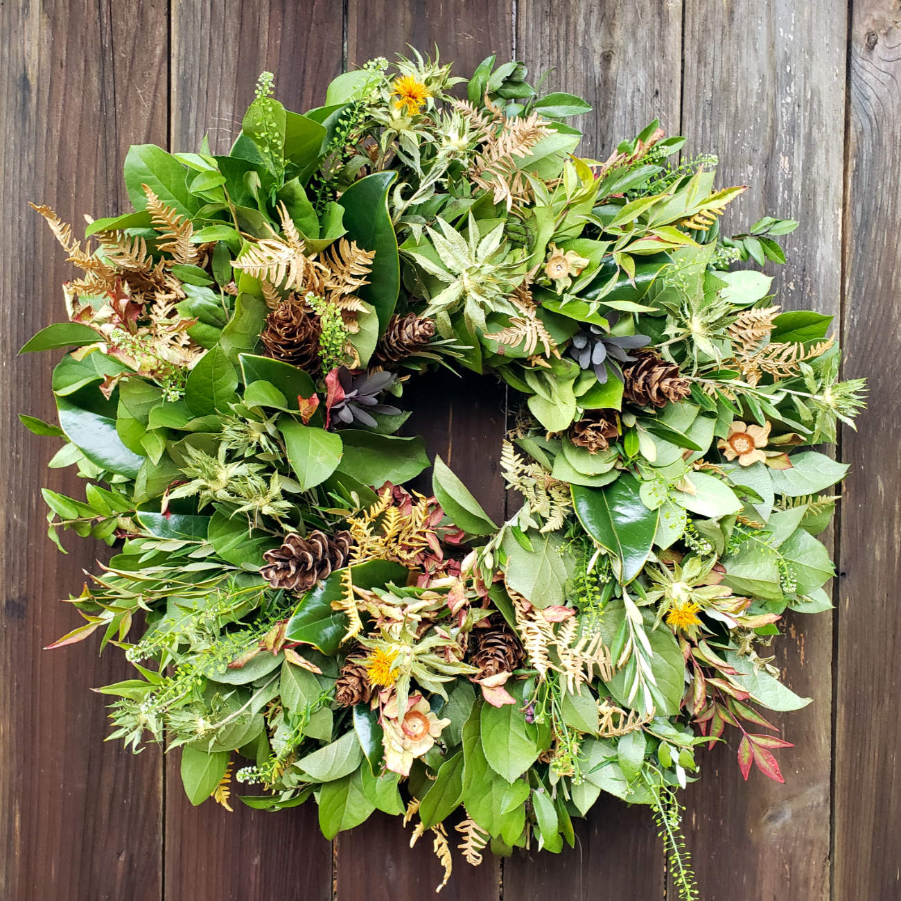 fresh and dried greens everlasting wreath on fence
